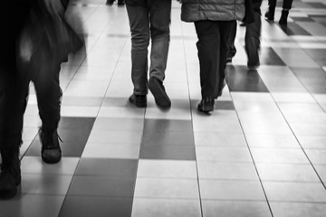 Fototapeta na wymiar Walking pedestrians in black and white. Pedestrians's legs while walking. 