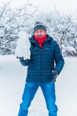 Fototapeta na wymiar People 50-60 years enjoy the life, season of christmas time, winter and snow concept - close up of man with snowball 