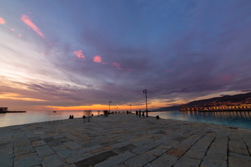 Colorful sunset in front of the city of Trieste