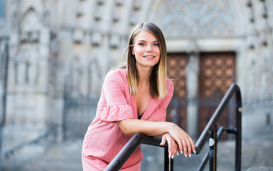 Woman standing  on handrail and the stairs in center of Barcelona