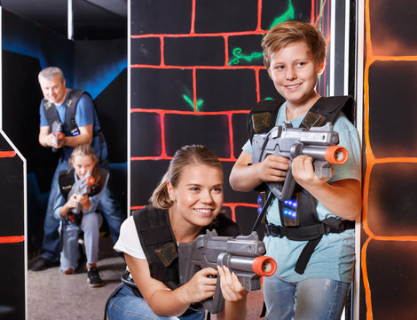 Mother and son with laser pistols playing laser tag