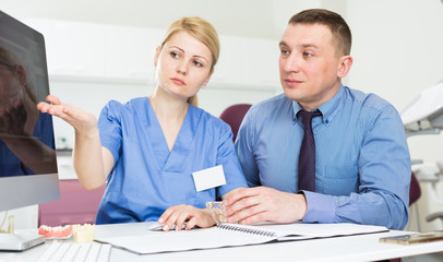 Obraz premium Female dentist discussing treatment with patient