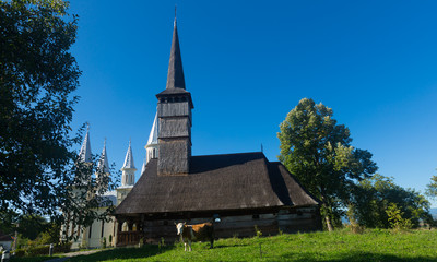 Fototapeta na wymiar Old and new edifices of church in Remetea Chioarului, Romania