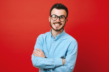 Photo of crazy smiling young man over red background