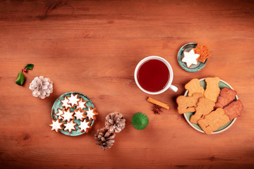 A Christmas background with Zimtsterne and Spekulatius, almond and cinnamon star cookies, and hot chocolate, with a place for text