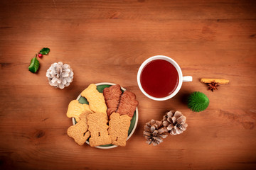 A Christmas greeting card with Spekulatius, almond biscuits, spices, and hot chocolate, shot from the top with copy space