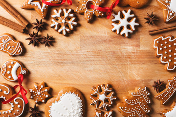 Gingerbread christmas cookies background on brown wooden texture