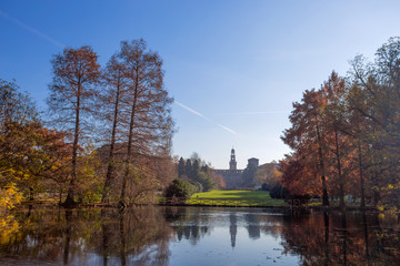 Autumn in Sempione Park with Sforzesco castle on the background in Milan, Italy.