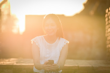 Fototapeta premium Asian beautiful girl has travel with happy and relaxing at Wat Chaiwatthanaram temple in Ayuthaya, Thailand.