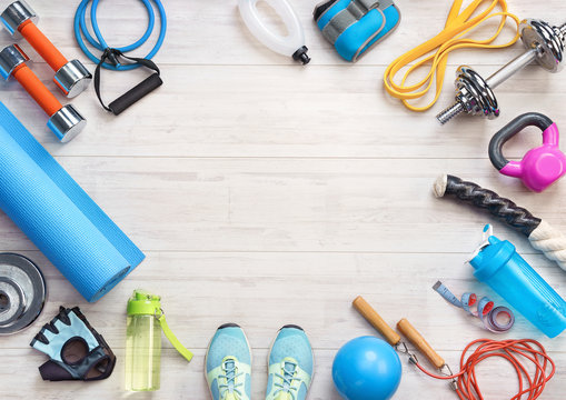 Sports equipment on a white wooden background. Top view. Motivation