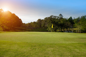 Fototapeta na wymiar The evening golf course has sunlight shining down at golf course in Thailand