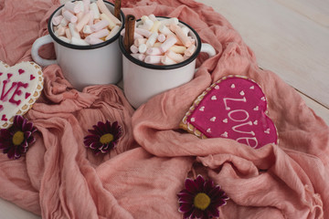 Romantic breakfast for valentine day. A delicious drink of marshmallows and heart-shaped cookies....