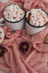 Romantic breakfast for valentine day. A delicious drink of marshmallows and heart-shaped cookies. Breakfast for lovers on a white table with pink textile
