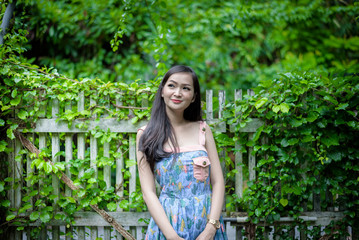 Asian pretty girl has relaxing with happy and smiling at Little Tree Garden cafe, Nakhon Pathom province, Thailand in the morning.