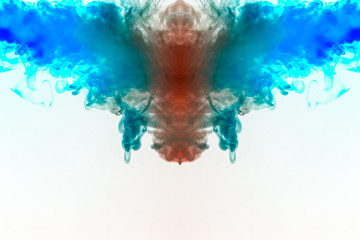 A multi-colored pattern of red and blue smoke of a mystical shape in the form of a face and a ghost's head or a strange creature on a white isolated background. Abstract pattern in of waves and steam