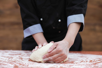 the cook makes flour for baking on the table