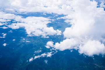 Naklejka na ściany i meble Sky scape cloudscape from aerial airplane shot of blue clouds. View flying from windows over Loei, Thailand.
