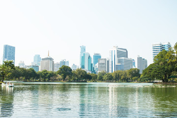 Fototapeta premium BANGKOK, THAILAND-DECEMBER 16,2018 : View of tower building Bangkok skyline at Lumphini Park, Pathum Wan districts of Bangkok.