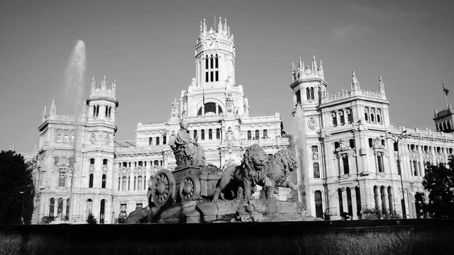 Madrid, Spain. Cybele Palace and fountain at the Plaza Cibeles in Madrid, Spain. Famous landmark in the evening with clear blue sky at the background. Black and white