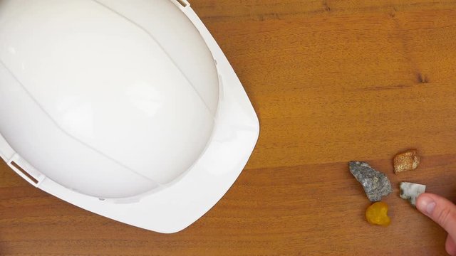 There is a white helmet and stones on the table.