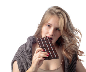 Happy young beautiful woman eating chocolate.