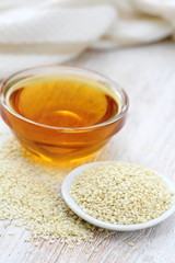 Sesame oil in glass and seeds