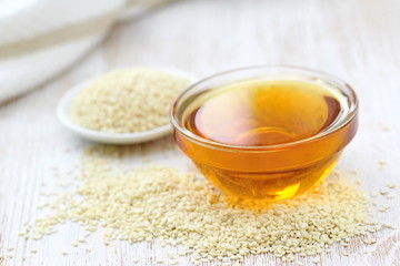 Sesame oil in glass and seeds