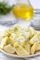 Boiled potatoes with greens and oil