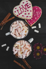Obraz na płótnie Canvas Romantic breakfast for valentine day. A delicious drink of marshmallows and heart-shaped cookies. Breakfast for lovers on a wooden table