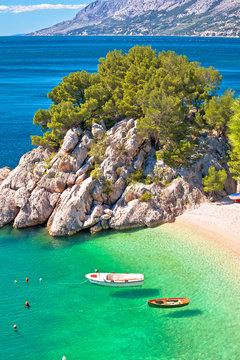 Idyllic emerald beach and boats in Brela aerial vertical view