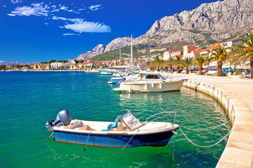 Colorful Makarska boats and waterfront under Biokovo mountain view - obrazy, fototapety, plakaty