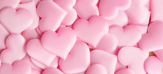 Valentine's Day. Pink heart shape backdrop. Abstract holiday Valentine background with pink satin hearts. Love concept. Flat lay, top view