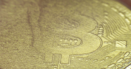 Crypto currency Gold Bitcoin - BTC - Bit Coin in gold paints.  Macro.

