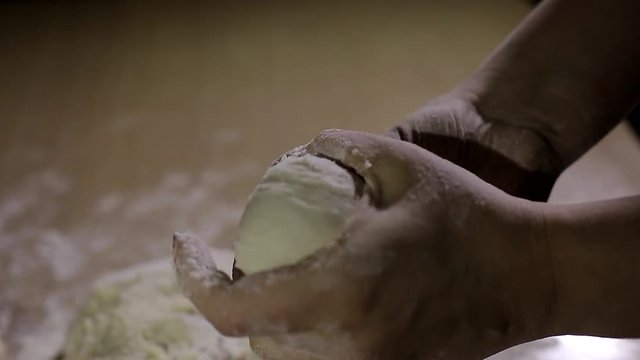 Women bake pies. Making buns. Dough on the table. Knead the dough.