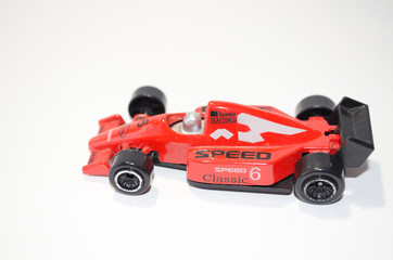 red toy race car on white background