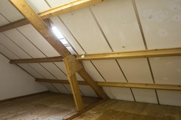 Obraz premium Attic, roof before construction with window and wooden beams