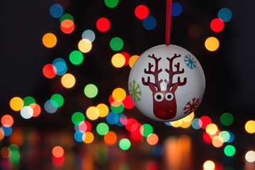 Christmas ball decoration hanging with a bukeh of christmas lights on background