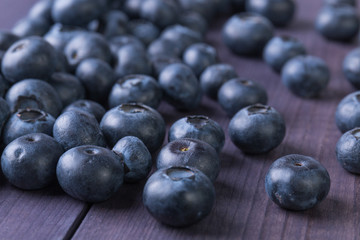 Fresh blueberry on rustic wooden table. Ripe berry background. Healthy food concept. Angle view