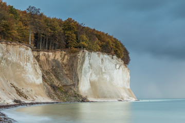 Chalk cliffs in the national park jasmund on the island reprimand. In the morning with calm sea in...