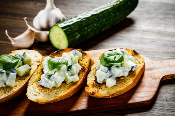 Bruschettas on cutting board on wooden background
