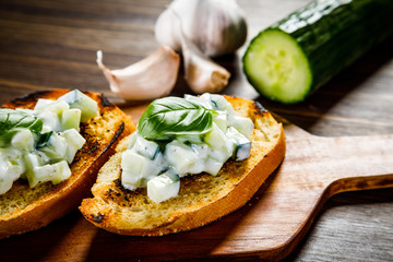 Bruschettas on cutting board on wooden background