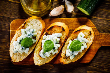Bruschettas on cutting board on wooden background