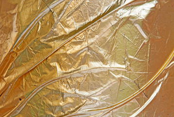 Gold leaf crumpled scratched uncommon texture.