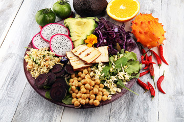 grilled tofu and dragon fruit buddha bowl with vegetable and humus