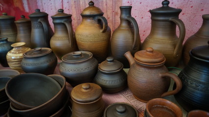 Fototapeta na wymiar Сlay pots and jugs, retro cooking utensils