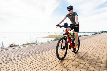 Fototapeta na wymiar Young man biking at seaside