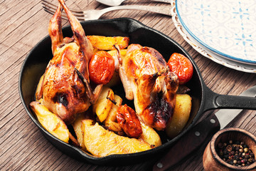 Baked whole quail with potatoes