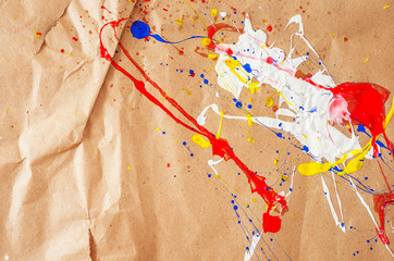 White and blue and yellow and red blemish on the paper