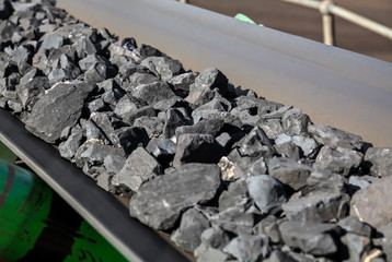 Close up of Manganese rock on a conveyor belt