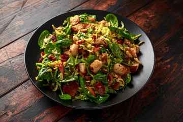 Roasted brussel sprouts, bacon warm salad with spinach, croutons and hazelnuts